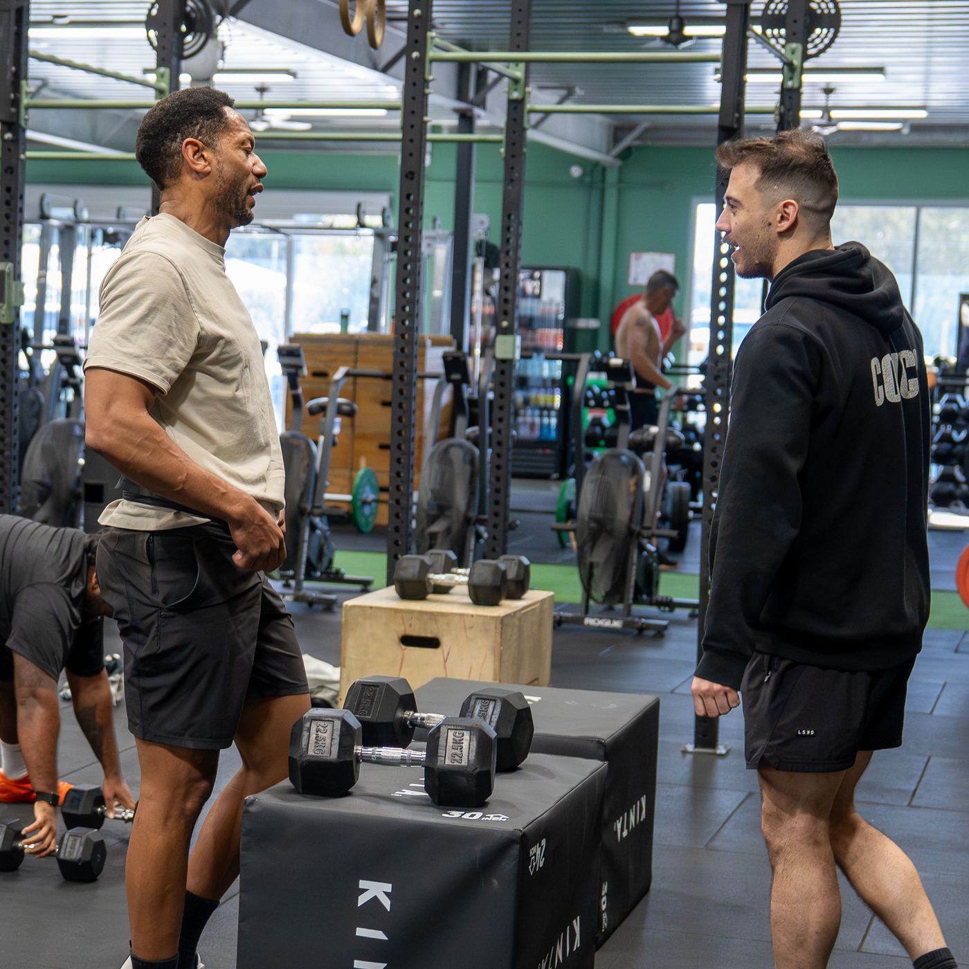 Two Sagitta coaches talking on the gym floor