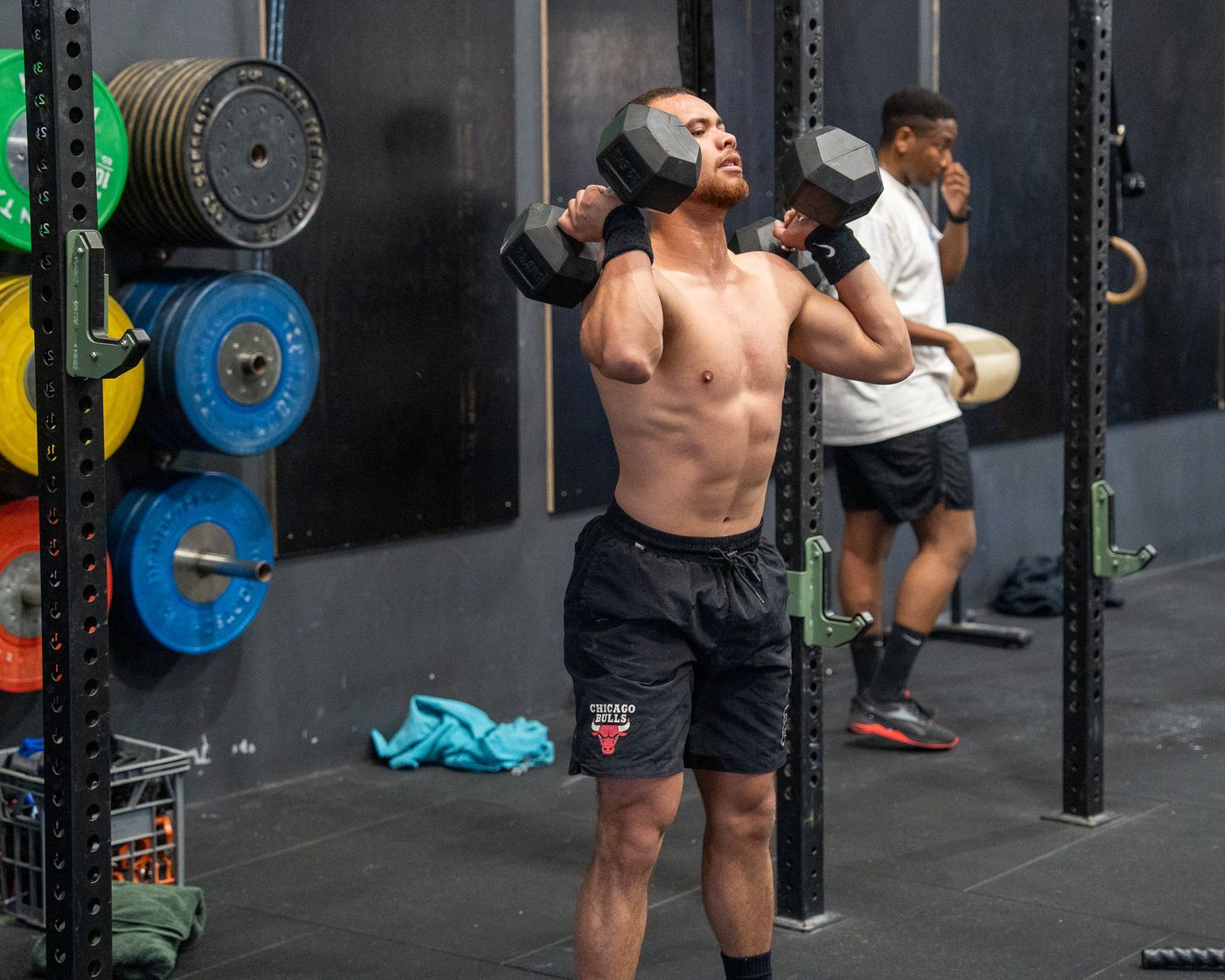 A member doing dumbbell work on the gym floor
