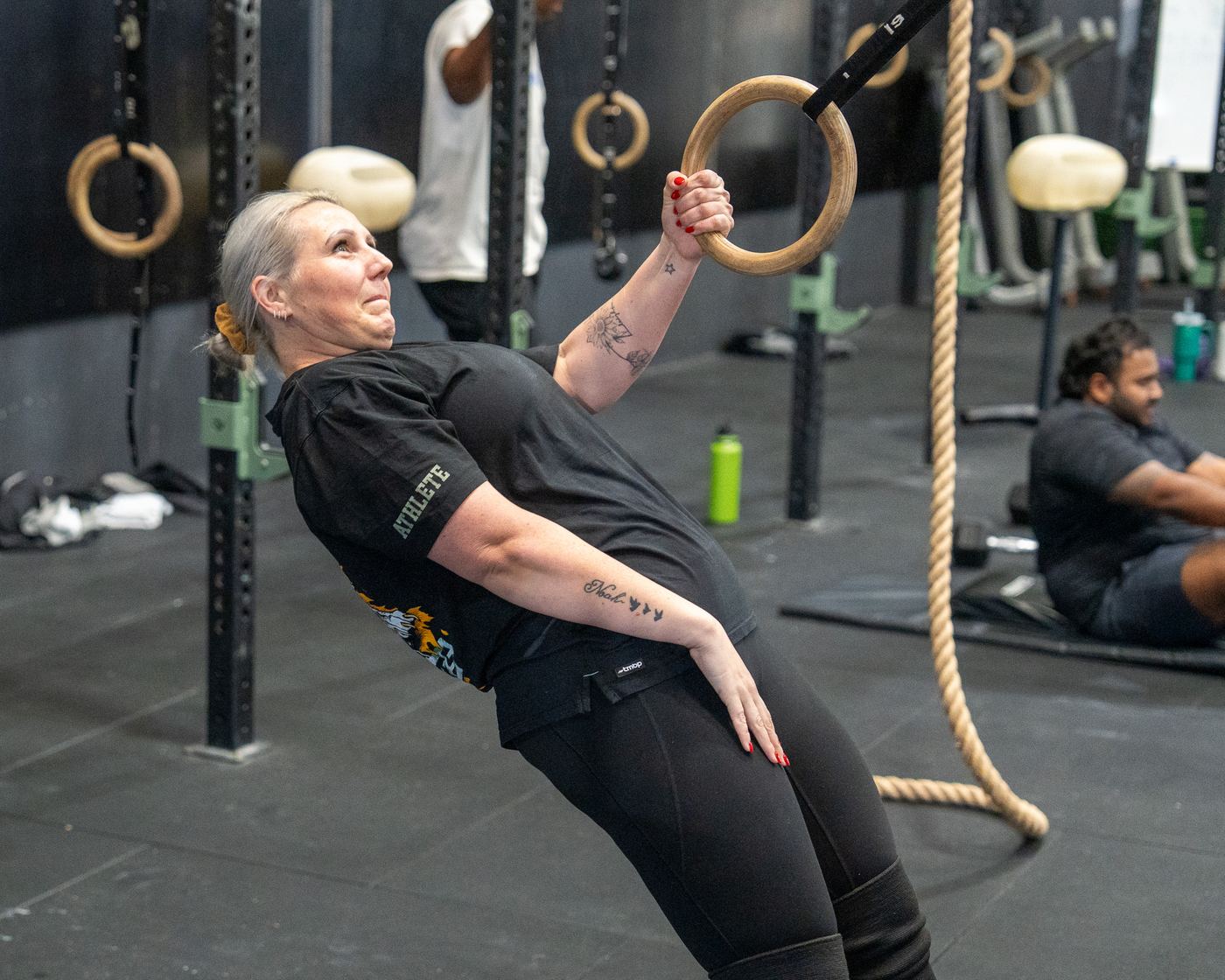A member doing ring rows