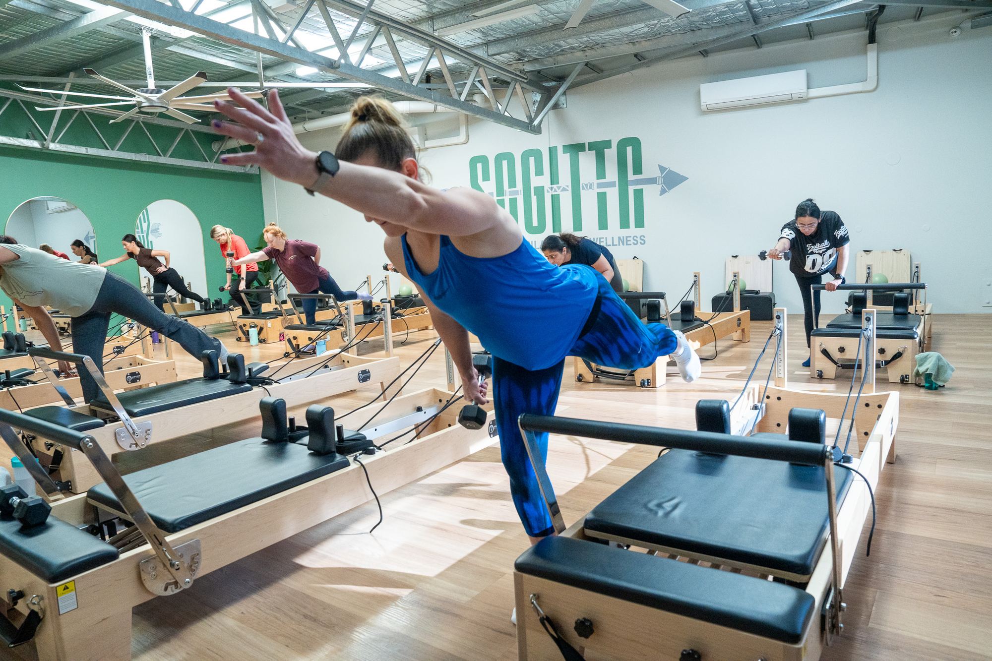 Members on reformers in the Sagitta Pilates studio